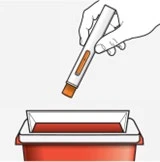A hand holding a white and orange injection pen above a red and white sharps disposal container