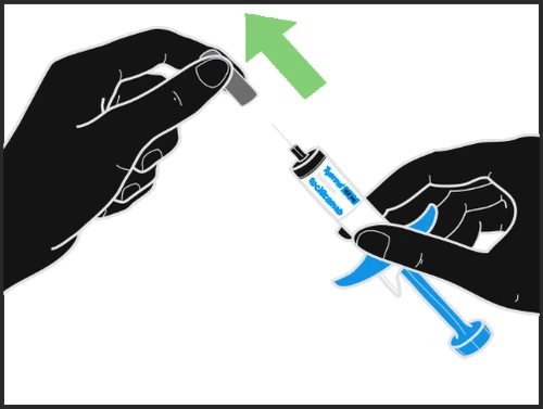 Two black hands demonstrate removing the gray cap from a syringe containing liquid and needle, while a green arrow indicates the upward removal motion