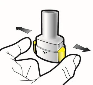 A hand holding a cylindrical white and gray medical device with black arrows indicating a horizontal rotational movement