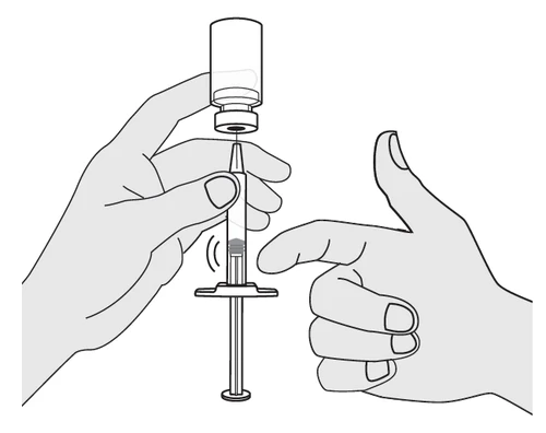 Two hands preparing a syringe with needle inserted into a glass vial to draw up the medication