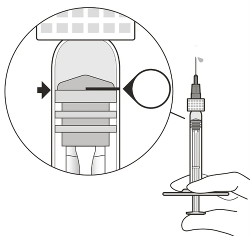 Technical diagram showing a hand holding a syringe with a close-up detail of the tip and graduated scale