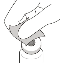 A hand gently lifting a small piece of adhesive tape or bandage applied over a white circular medical device