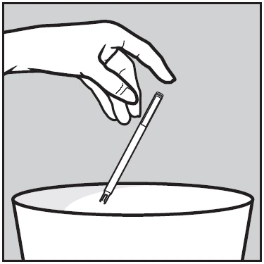 A hand holding an injectable pen at an angle while inserting the tip into the opening of a sharps disposal container
