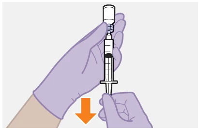 Two gloved hands holding a syringe with dark liquid beneath a vial with an orange arrow pointing downward