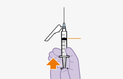 A hand holding a syringe with needle pointing upward