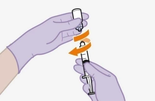 Two hands with purple gloves unscrewing a white cap from a syringe following the movement indicated by two curved orange arrows