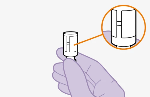 A hand holding a white cylindrical medical device with a magnified detail in an orange circle showing a central slit