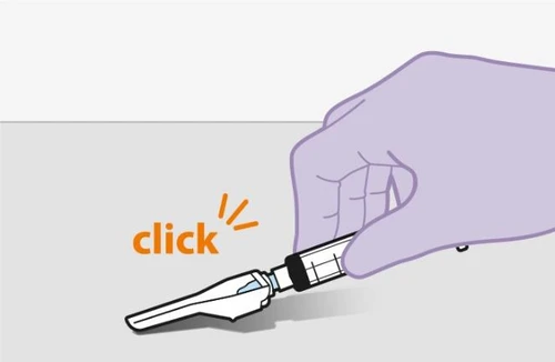 A gloved hand holding a pen-shaped medical device emitting a 'click' sound as it is pressed onto a gray surface