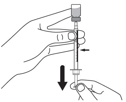 A hand holding the upper part of a syringe while another component is being manipulated