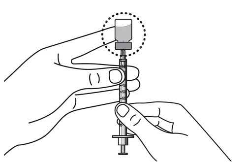 Two hands handling a syringe with a drug vial on top, with millimeter markings on the syringe barrel