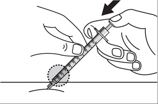 Two hands gripping a tilted syringe to inject liquid through the needle