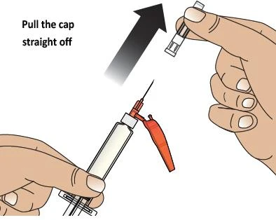 One hand lifting the transparent cap of a syringe upward