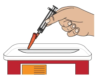 One hand holds a syringe with needle and orange tip injecting liquid into a white surface above a red and orange base