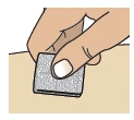 One hand applies a small square gray adhesive bandage to the light skin of an arm or leg