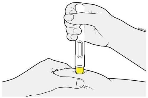 A hand holds a vertical injection pen while another element is implied