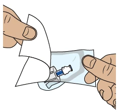 Due mani aprono una confezione di plastica trasparente per estrarre un dispositivo medico con un cappuccio blu e una base bianca