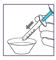 Una mano impugna una siringa graduata con un pistone azzurro per aspirare un liquido contenuto in una ciotola bianca