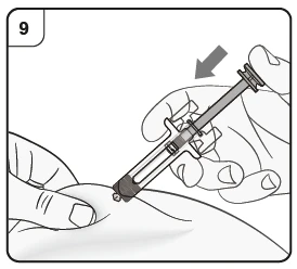 A hand holds a syringe with needle while the