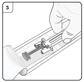 A hand holds a medical device shaped like a syringe at the