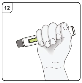 A hand firmly holds a pen-shaped medical device with a transparent reservoir containing yellow liquid and the number 12 in the top left corner