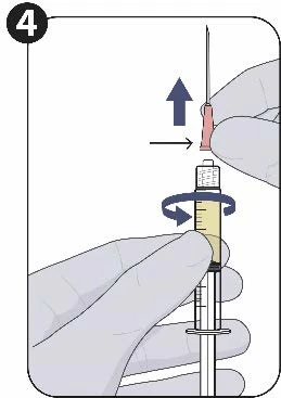 Gloved hands drawing liquid into a syringe