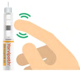 A hand lightly touches with a finger a white cylindrical medical device with an orange label and black text surrounded by green waves