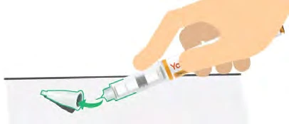 A hand holds a pre-filled syringe and the tip is shown while removing the green plastic protective cover for the