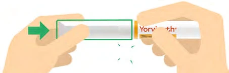 Two hands hold a white and transparent medical device with a green arrow indicating the direction of push toward the