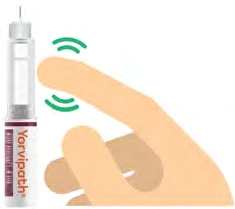 A hand holds a syringe with the needle pointing toward the