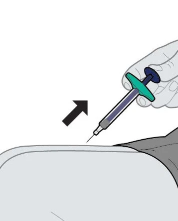 A hand holds a syringe with liquid and the tip of the needle ready for injection