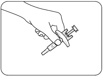 A hand holding a syringe with a white protective device and a plunger for injection