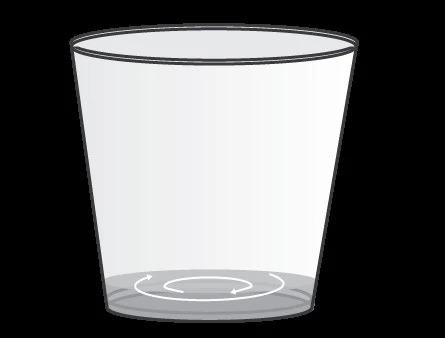 A transparent glass with a white circular arrow at the bottom indicating a clockwise rotational movement