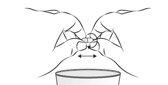 Line drawing of two hands holding a small object between fingers with a horizontal double arrow indicating lateral movement