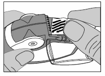 Two hands holding and preparing a medical device showing the mechanism and a component with black lines visible at the top