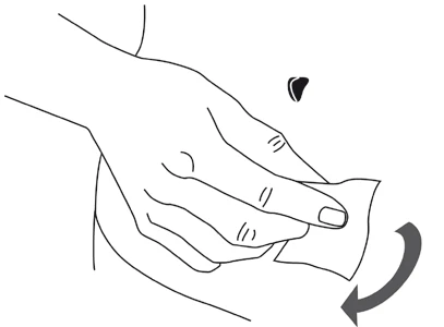 Hand holding a white wipe performing a circular motion on the abdominal skin, suggesting a cleansing or medication application process