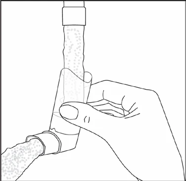 Hand holding a transparent connector piece joining two segments of a tube filled with small air bubbles or fluid