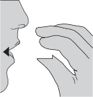 A person's face in profile with open mouth and a hand holding a small object approaching the mouth, indicating the method of medication intake