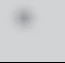 Blurred, dark gray patch with irregular, jagged edges on a uniform light gray background