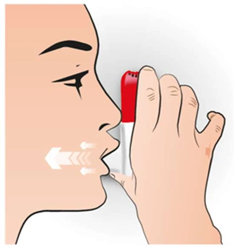 Side profile of a person holding a red-and-white inhaler to their mouth, with white arrows indicating the direction of airflow into the oral cavity