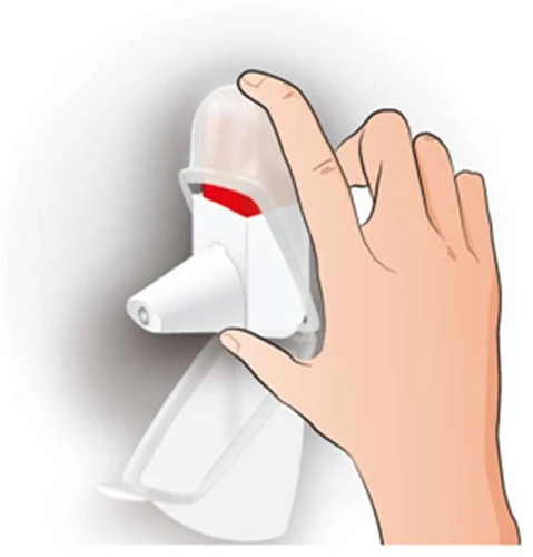 Hand holding a white inhaler with a transparent cover, showing a red horizontal line indicating the medication level