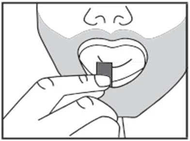 A hand holding a small rectangular tablet and bringing it closer to the open mouth of a man for swallowing the medication