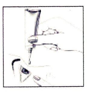 Hand holding a tube of medication, from which a small amount of the preparation is being squeezed onto a finger for application to the skin