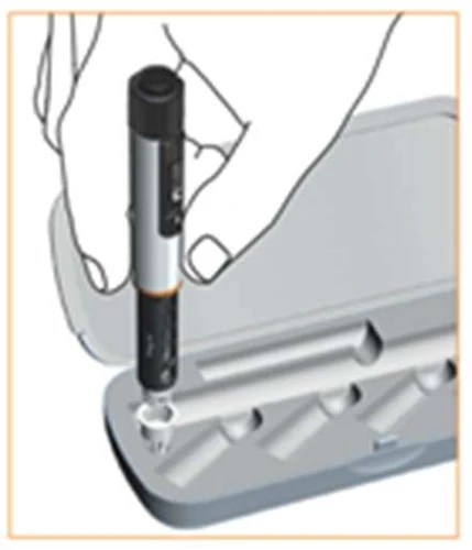 Hand vertically holding a black and silver pen-type injector being removed from a fitted gray protective case with contoured openings