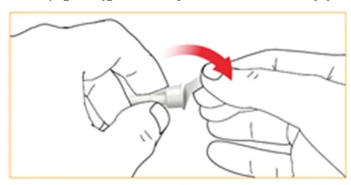 Two hands holding a white medical component; one hand performs a clockwise rotational motion indicated by a red arrow pointing right