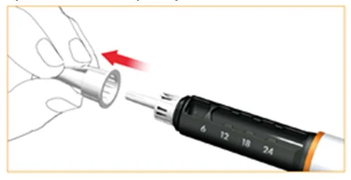 Hand attaching a white cap onto the tip of a black injector with a millimeter scale, indicating preparation of the device for use
