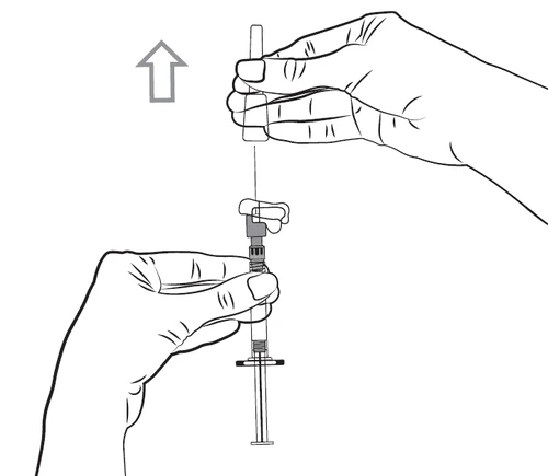 Hand holding a syringe with a needle, the other hand moving vertically upwards to connect components of the drug delivery mechanism
