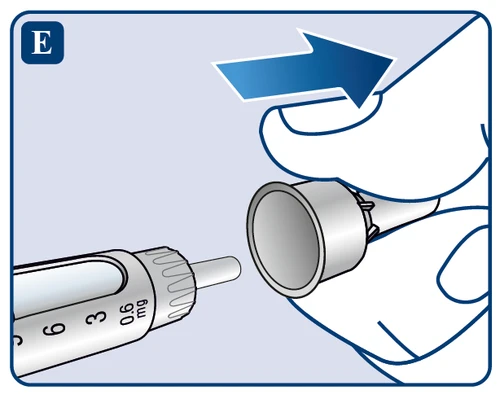 Close-up of a hand removing a white cap from the syringe tip with a milligram scale, with a blue directional arrow above