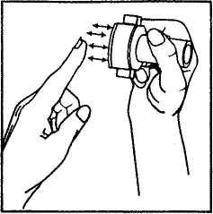 A hand holding an inhaler close to the index finger, with arrows indicating the direction of released medication toward the hand and finger