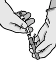Two hands holding a syringe and a vial of medication, one hand stabilizing the vial while the other presses the syringe plunger to draw the medication