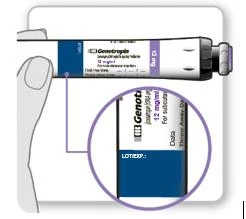Hand holding a Genotropin 12 mg medication pen, with a magnified inset showing a close-up of the label marked LOT/EXP and a blue data strip